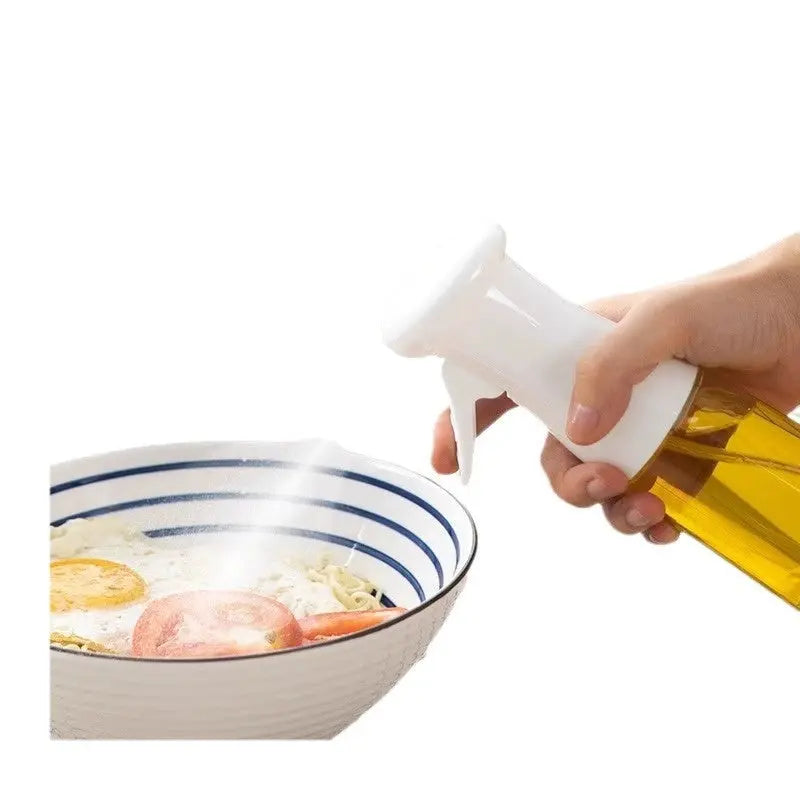 ChefMist oil sprayer misting oil over a bowl of food